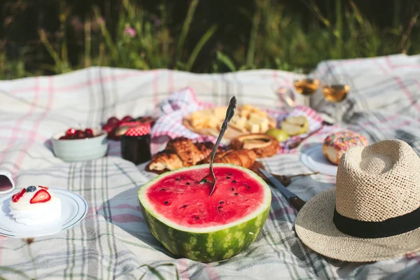 summer picnic on the rug. Fruits, berries, pastries and cheese