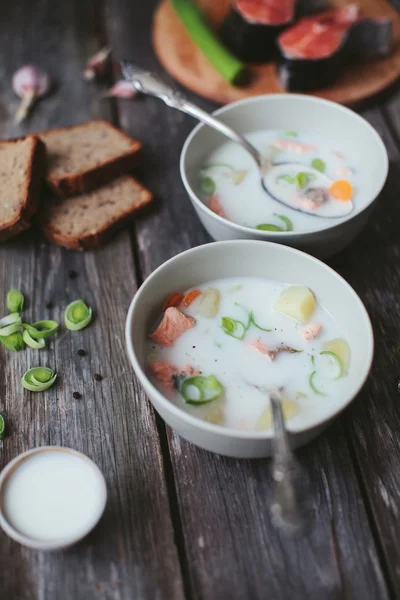 Finnish dairy ear with red fish in a plate with a spoon on a wooden table — Stock Image Finnish dairy ear with red fish in a plate with a spoon on a wooden table Royalty Free Stock Photos
