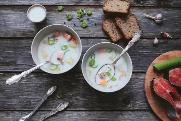 Finnish dairy ear with red fish in a plate with a spoon on a wooden table — Stock Image Finnish dairy ear with red fish in a plate with a spoon on a wooden table Stock Picture