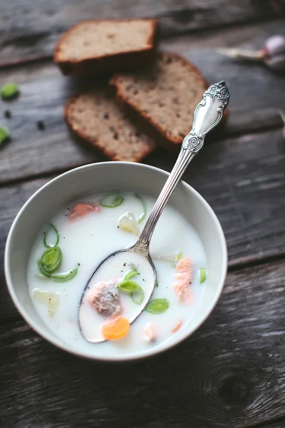 Finnish dairy ear with red fish in a plate with a spoon on a wooden table — Stock Image Finnish dairy ear with red fish in a plate with a spoon on a wooden table Royalty Free Stock Images