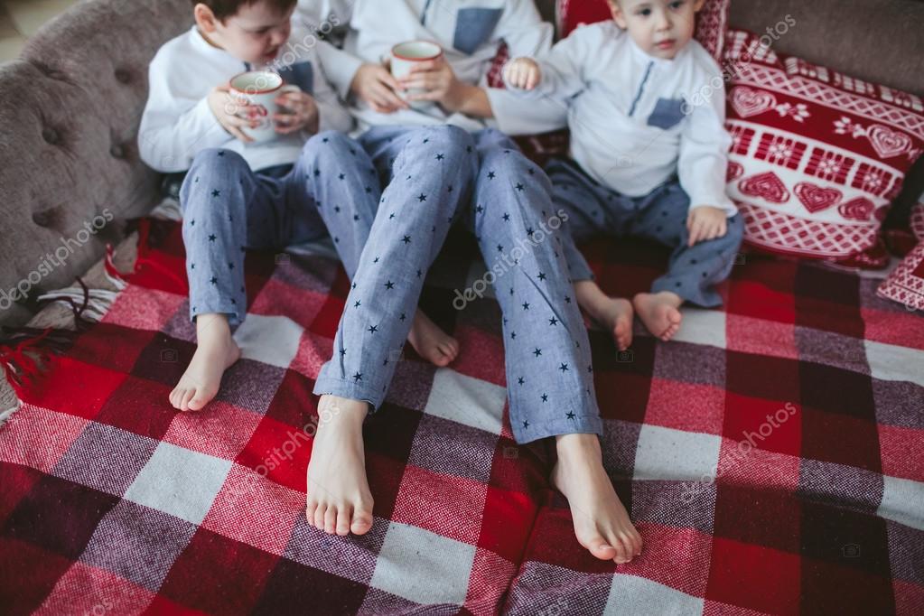 Legs Young Brothers In Identical Pajamas Holding Mugs Of Milk