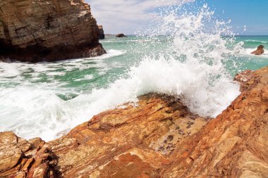 wave and splashes on beach of cathedrals in ribadeo, Galicia, Sp clipart