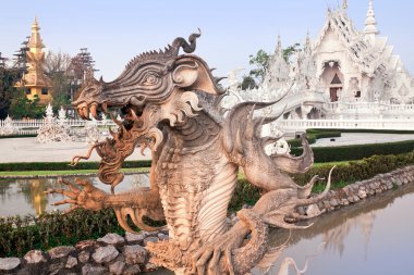 Sculpture of a dragon on a background of temple Rong Khun, Chiang Rai, Thailand