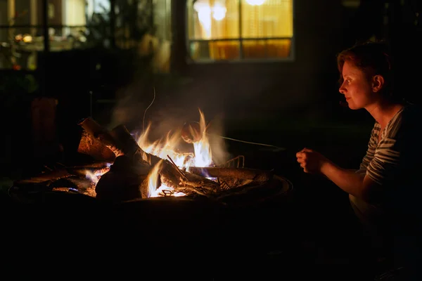 Woman and bonfire at night Stock Image