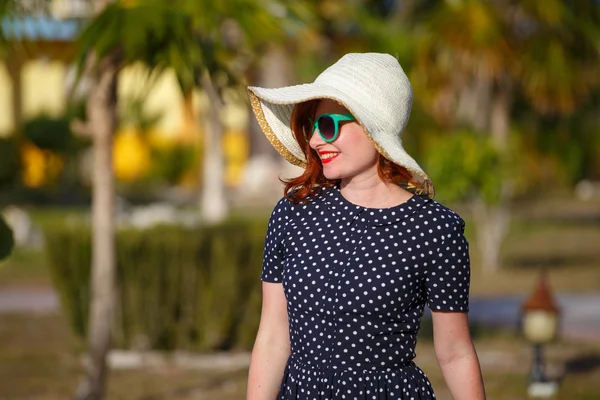 Young woman in polka-dot dress and straw hat — Stock Photo, Image