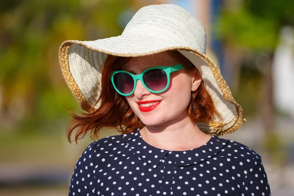 Young woman in polka-dot dress and straw hat — Stock Photo, Image