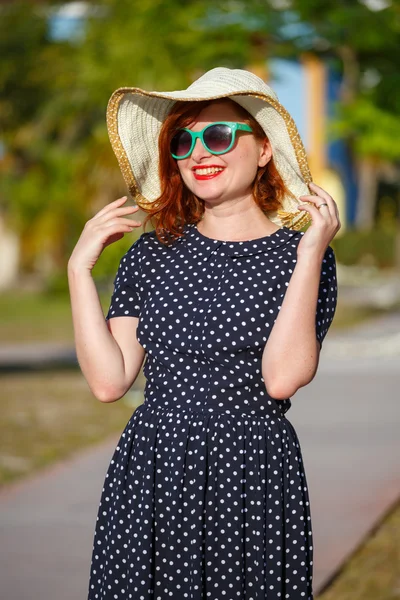 Young woman in polka-dot dress and straw hat — Stock Photo, Image