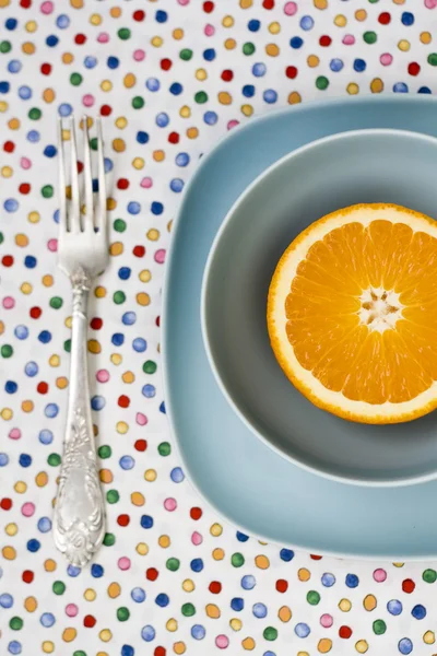 Saftig apelsin på blå tallrik för frukost — Stockfoto