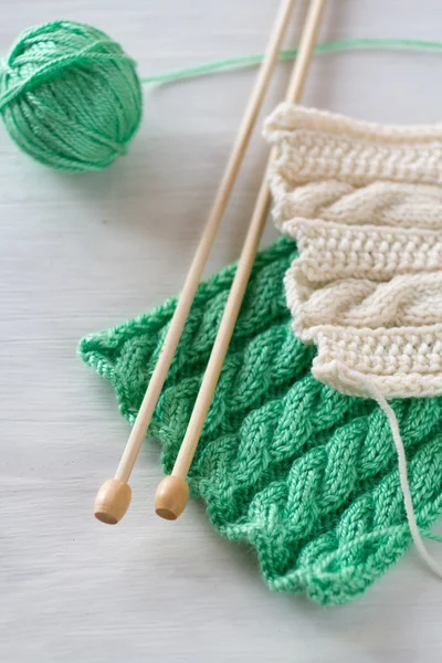 Two bright patterns and wooden knitting needles for a white back — Stock Photo, Image