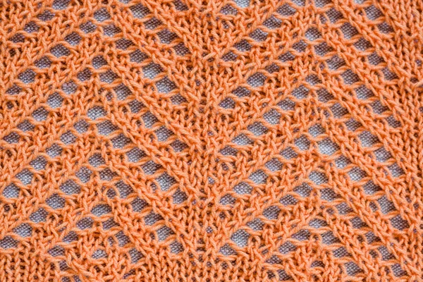 Openwork pattern with orange thread on a light background — Stock Photo, Image