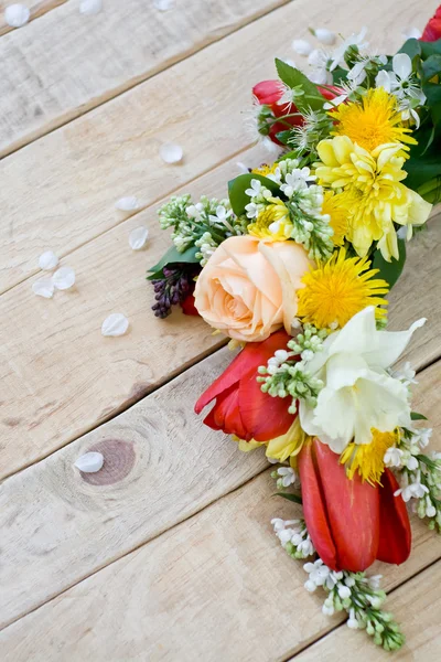 Bouquet of colorful spring flowers lying on the unpainted wooden — Stock Photo, Image