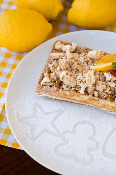 Waffles with meringue, lemon curls and orange slices — Stock Photo, Image