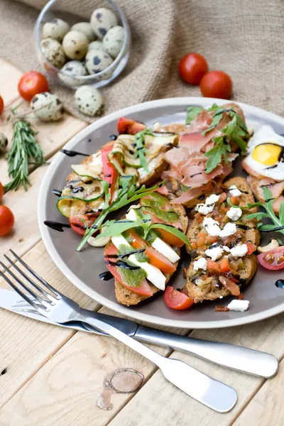 Many delicious bruschetta with cheese, tomato, quail egg, ham, s — Stock Photo, Image