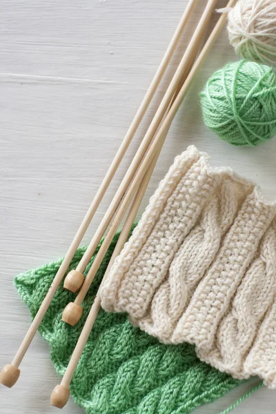 Two bright patterns and wooden knitting needles — Stock Photo, Image