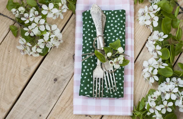 Two forks on rustic wooden background and branches with flowers — Stock Photo, Image