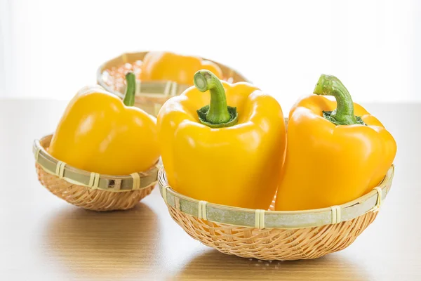 Fresh yellow bell peppers in basket