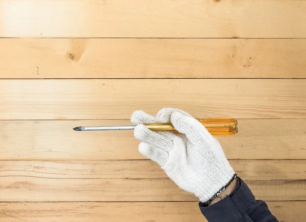 Hand in glove holding screwdriver — Stock Photo, Image