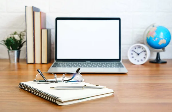 Glasses and notepad with Blank screen laptop computer on deck, Workplace with laptop on table at home,Work form home concept