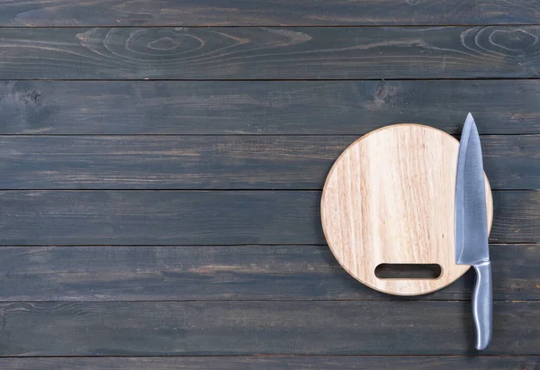 木製のテーブルの上にキッチンナイフと丸板を閉じます — ストック写真