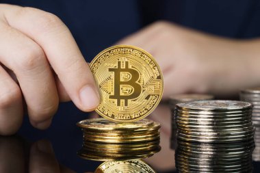 İş kadınının elinde Bitcoin 'in bazı altın parçalarını tuttuğu yakın plan Bitcoin popüler kripto para birimlerinden biridir.