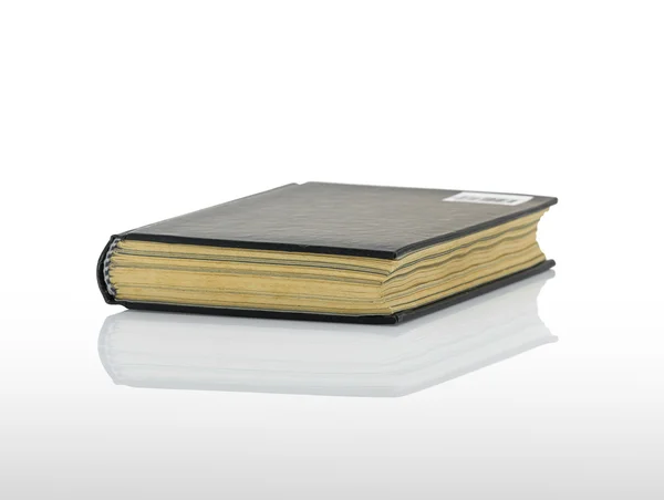 Closed black book with shadow on white background — Stock Photo, Image