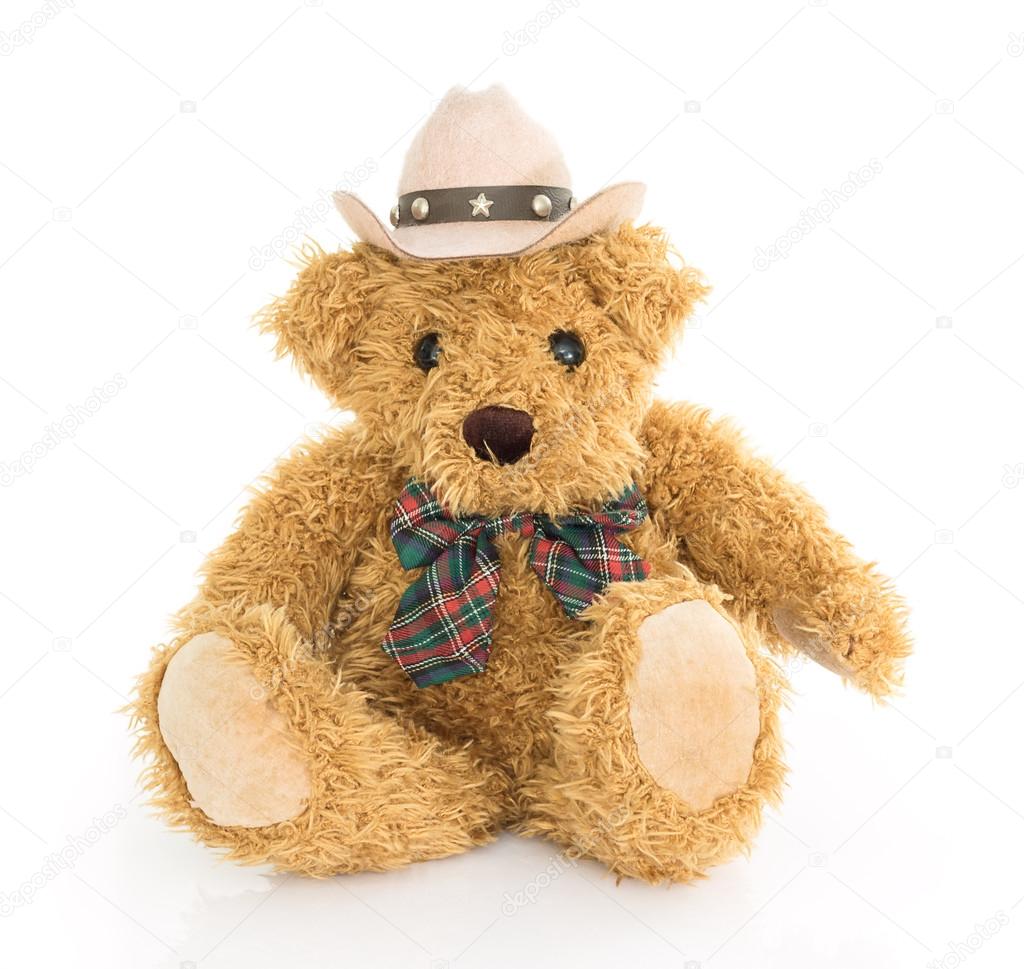 Cowboy teddy bear sitting on white