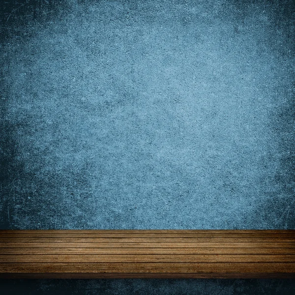 Wood table and blue concrete wall — Stock Photo, Image