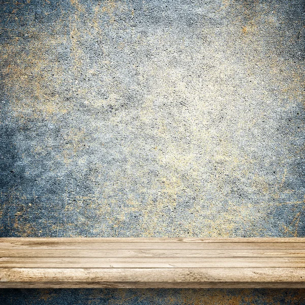 Wood table and blue concrete wall — Stock Photo, Image