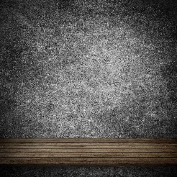 Houten tafel en grijze betonnen wand — Stockfoto