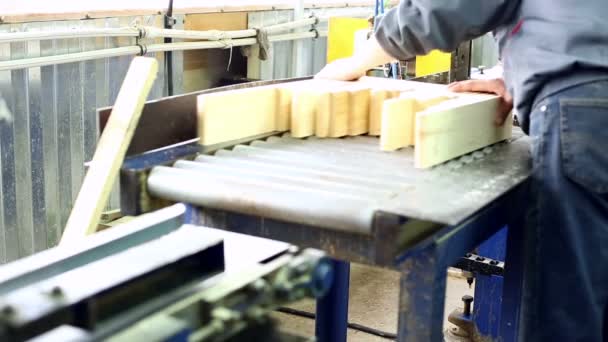 View on worker puts glued lamellas in machine — Stock Footage View on worker puts glued lamellas in machine Video Clip