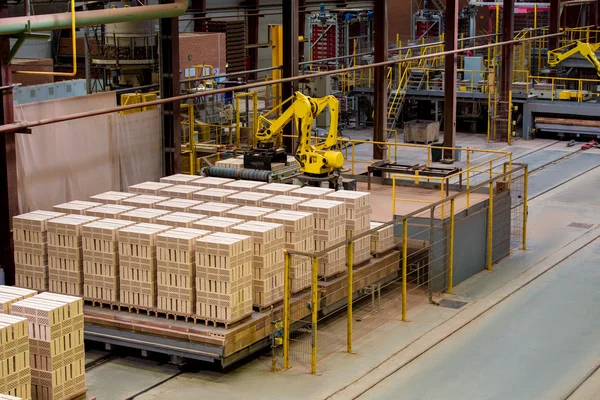 Manufactured bricks stacked on pallets in workshop — Stock Photo, Image