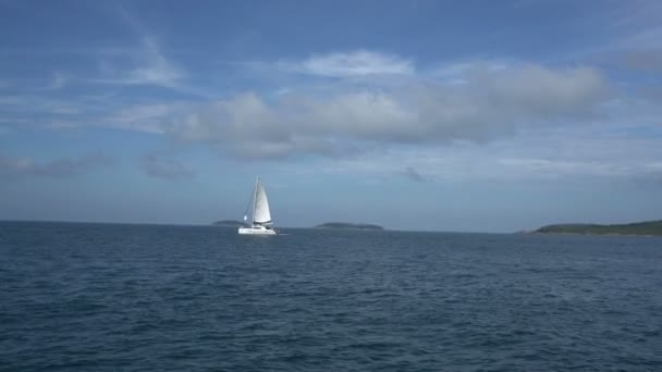 View of sailing yacht in sea and islands far away — Stock Video