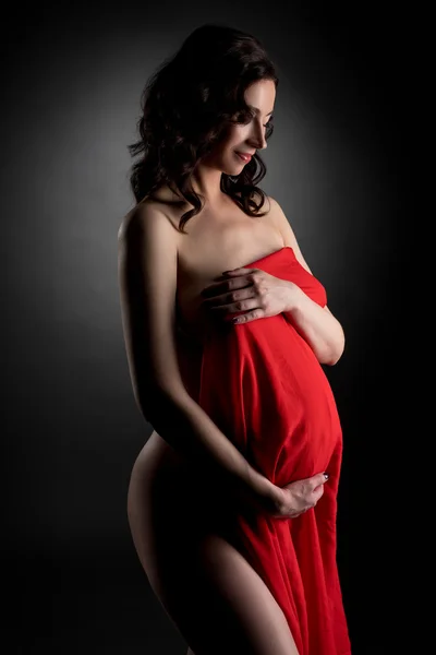 Nude expectant mother posing smiling shyly — Stock Photo, Image