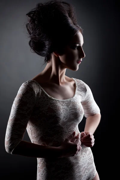 Shot of brunette posing in lace bodysuit like doll — Stock Photo, Image