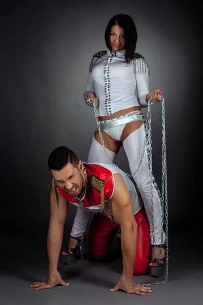 Dance show. Imperious woman and guy in chains — Stock Photo, Image