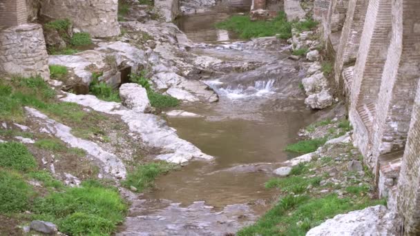 Vue sur le ruisseau coulant parmi les pierres et les ruines — Video