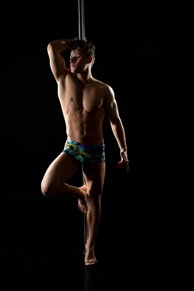 Male pole dance. Photo of muscular man posing — Stock Photo, Image
