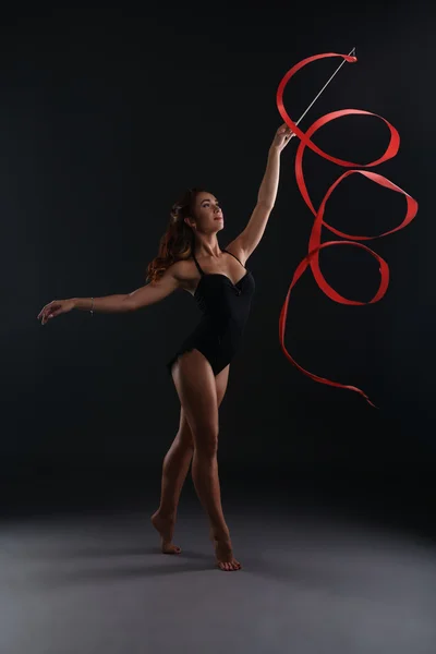 Studio photo of sexy brunette dancing with ribbon — Stock Photo, Image