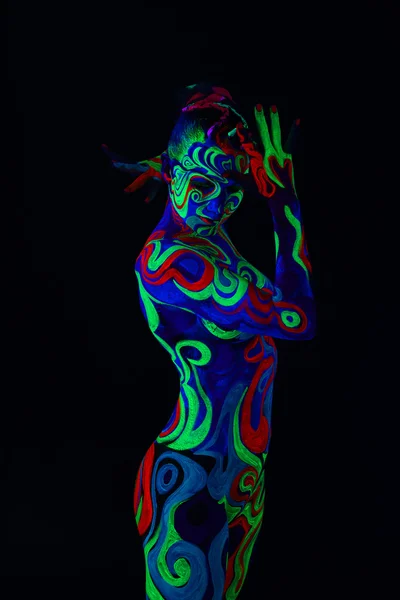 Girl with body art glowing in ultraviolet light — Stock Photo, Image