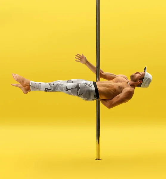 Photo of modern male dancer performing on pylon — Stock Photo, Image