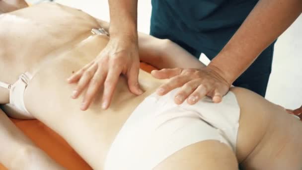 Crop osteopath massaging back of female patient — Stock Video