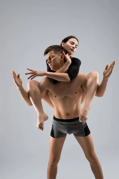 Shirtless male carrying young female on back — Stock Photo, Image