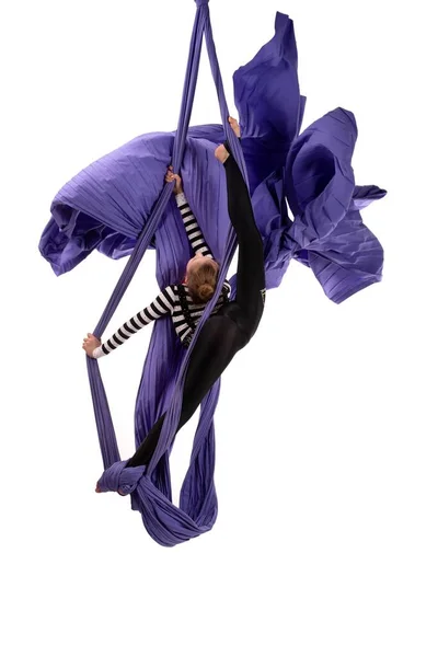 Flexible girl doing aerial silks trick on fabric — Stock Photo, Image