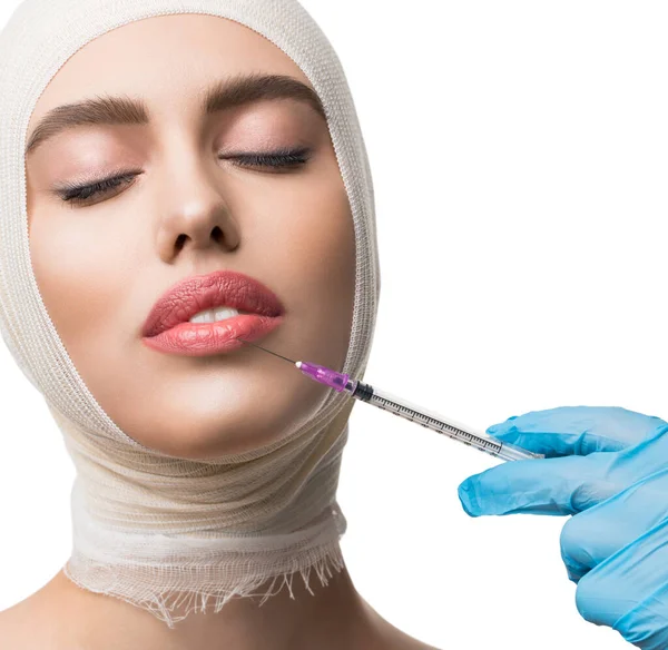 Woman her head bandaged getting lips injections — Stock Photo, Image