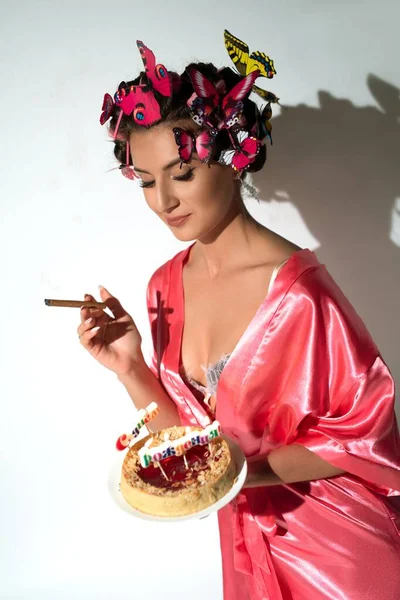 Doğum günü pastasıyla iç çamaşırlı genç bir kadın. — Stok fotoğraf