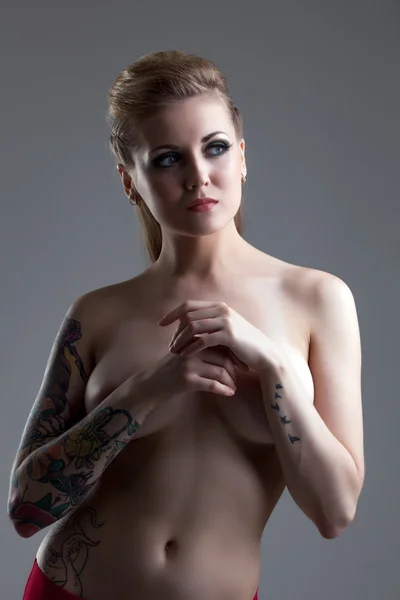 Imagem de mulher tatuada em topless posando em estúdio — Fotografia de Stock