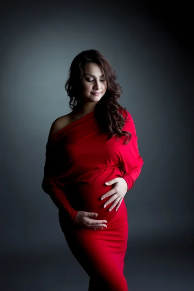 Elegant expectant mother posing in studio — Stock Photo, Image