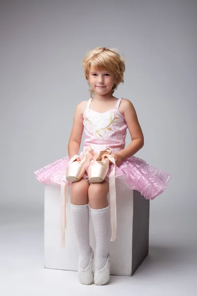 Nice little ballerina posing with pointes — Stock Photo, Image