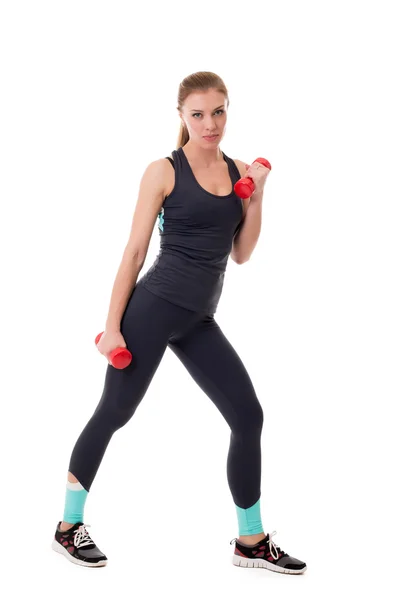 Sexy sportswoman exercising with dumbbells — Stock Photo, Image