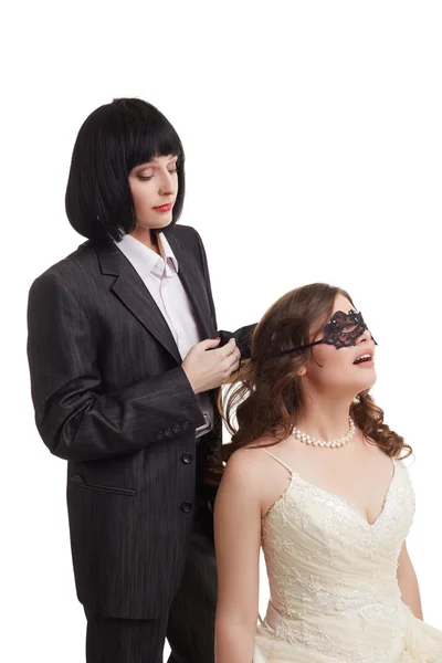 Gay marriage. Groom tied mask over brides eyes — Stock Photo, Image